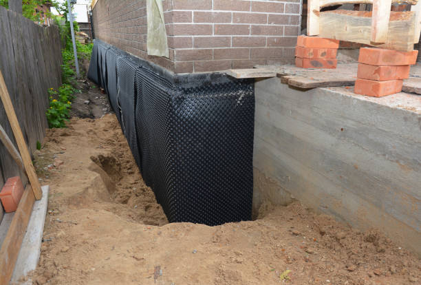 SJ Waterproofing Pros technician performing targeted Exterior Waterproofing assessment in Windfall, IN